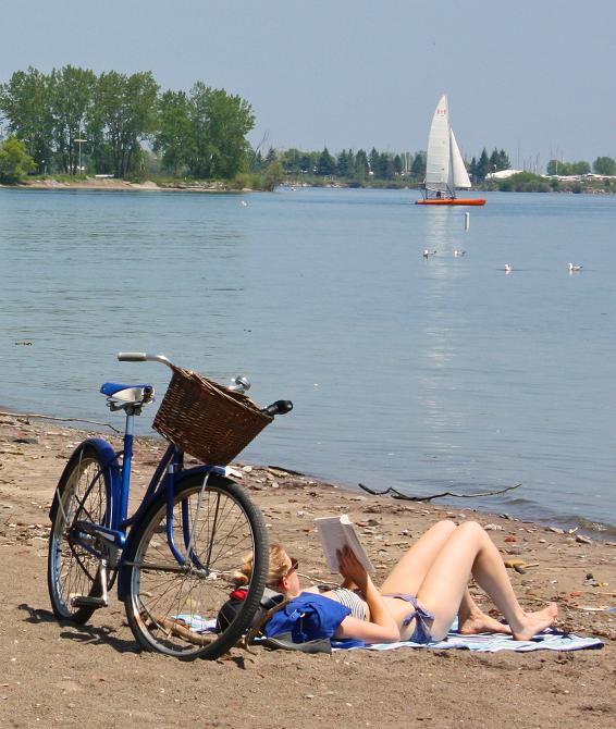 girl-reading-bike-beach-close-web